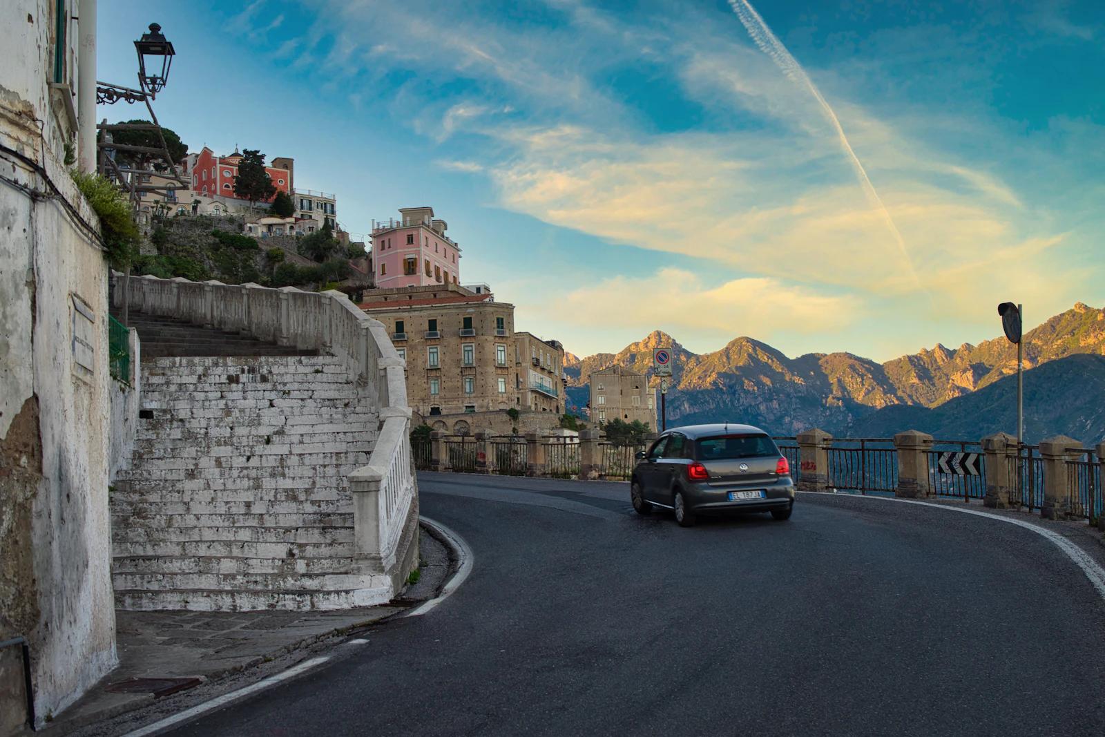 SUV driving along a coastal road on the Amalfi Coast, Italy